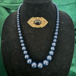 Vintage Act II broach and dark blue costume necklace.